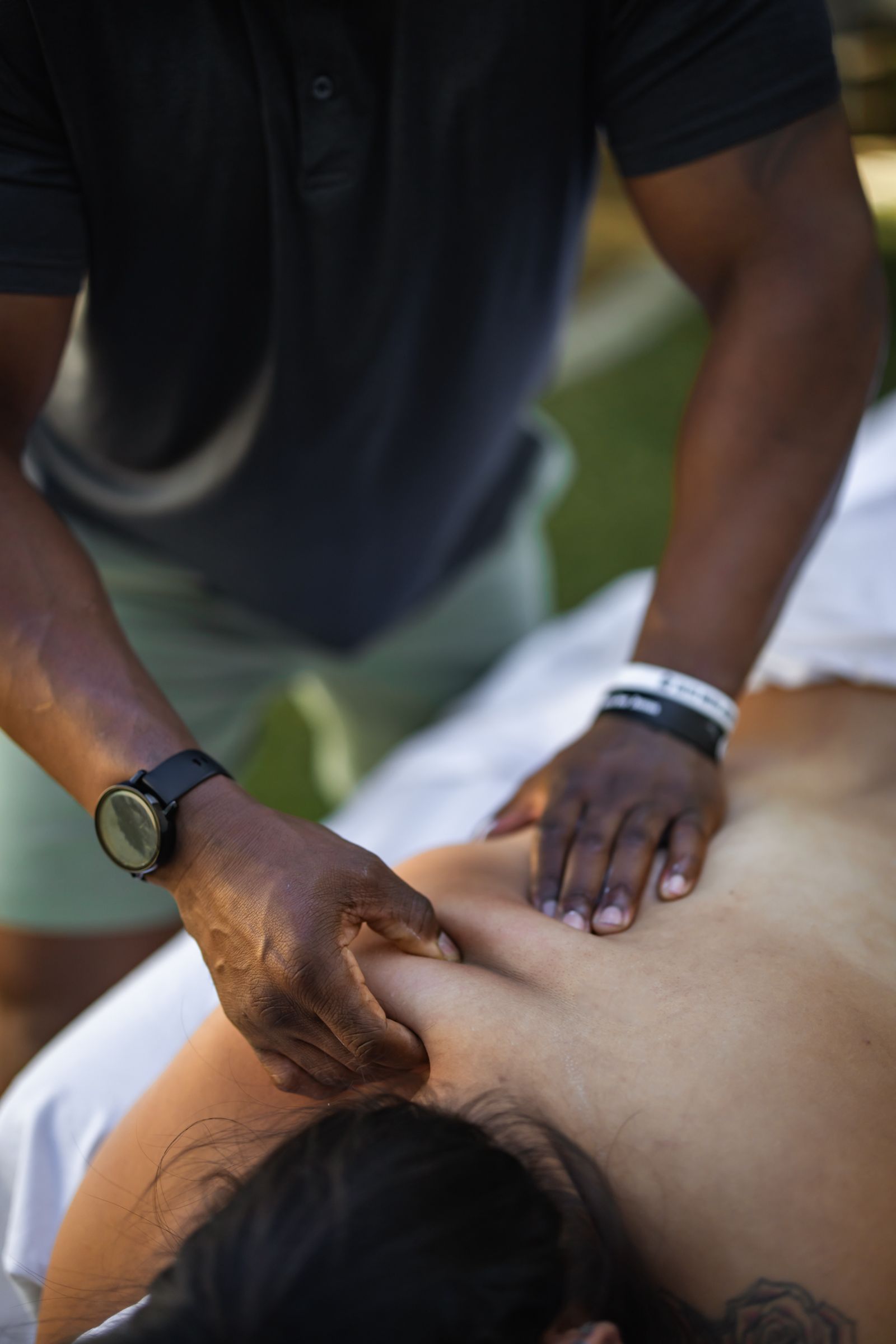 Koma Massage assisted stretching session outdoors under string lights — mobile massage photography by Murrieta Media, Temecula