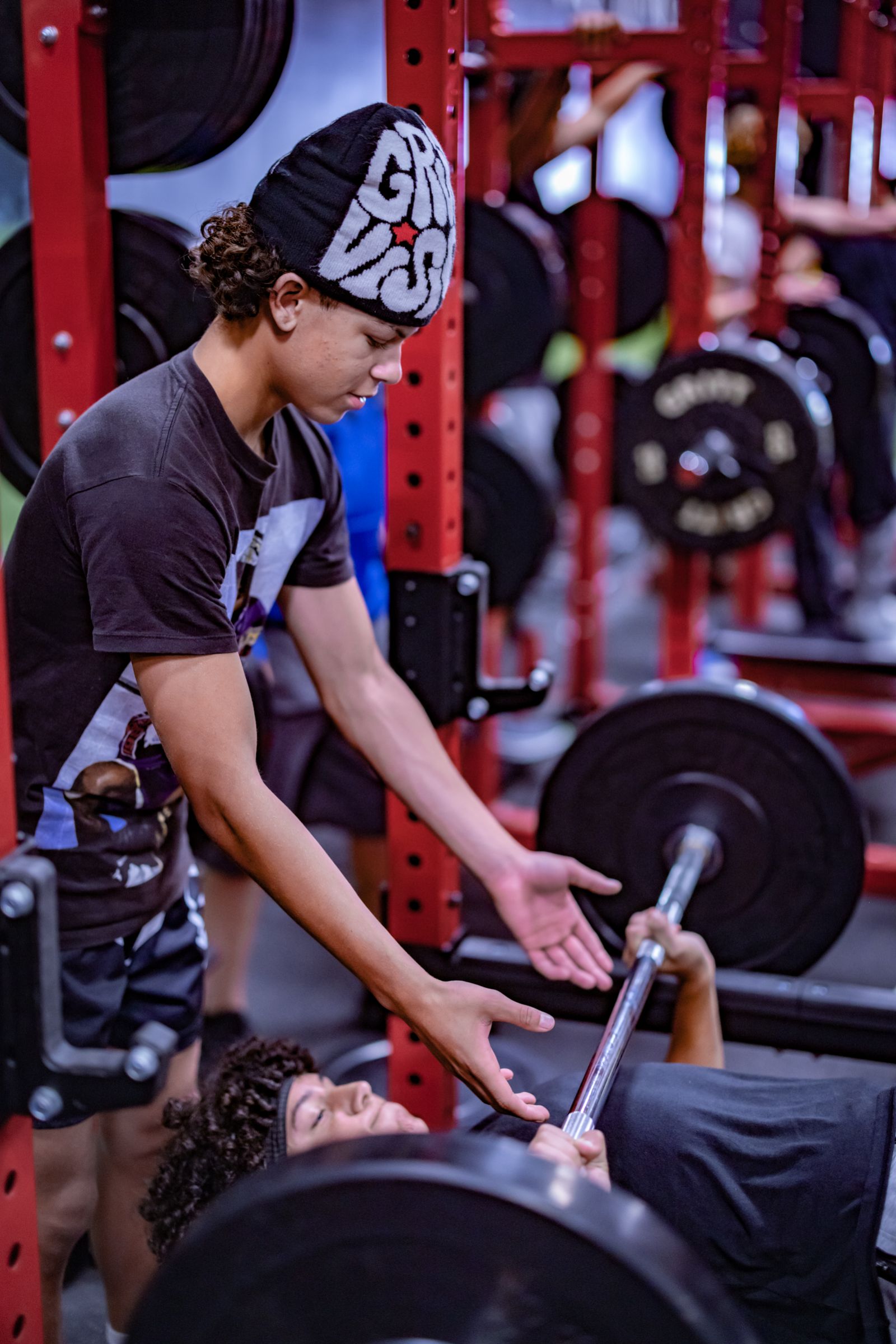 Young athlete spotting bench press in the Empire Sports Academy weight room — sports photography by Murrieta Media, Murrieta California