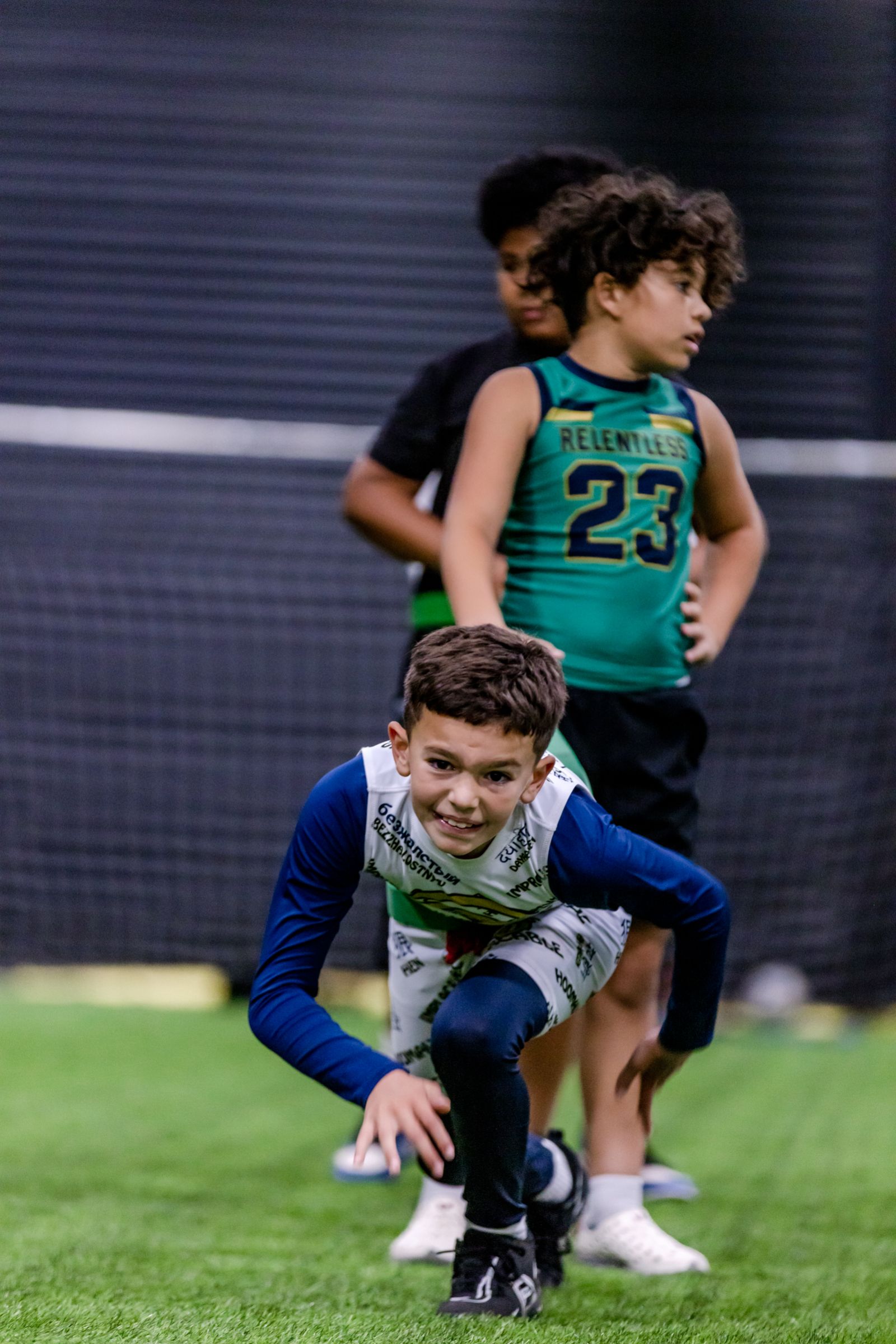 Young flag football players competing on the indoor turf at Empire Sports Academy — youth sports action photography by Murrieta Media, Murrieta California